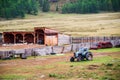 Old wheeled tractor near the fence of a livestock farm Royalty Free Stock Photo