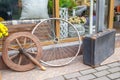 Old wheels and dirty suitcase near antique shop in town Royalty Free Stock Photo