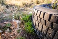 Old wheels of unrecycled cars thrown in a natural field pollute the earth Royalty Free Stock Photo