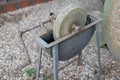 An old whetstone for sharpening knives. Grinding wheel on an old