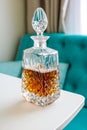 Old whisky decanter standing on a white wooden table