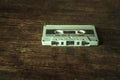 Old white audio cassette on a wooden table Royalty Free Stock Photo