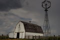 Old white barn sitting under thunder storm clouds. Royalty Free Stock Photo