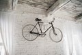 Old white bicycle whist on a white stone wall. Royalty Free Stock Photo
