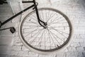 Old white bicycle whist on a white stone wall. Royalty Free Stock Photo