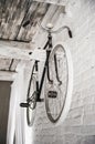 Old white bicycle whist on a white stone wall. Royalty Free Stock Photo