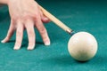 Old white billiard ball and stick on a green table. billiard balls isolated on a green background Royalty Free Stock Photo