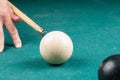 Old white billiard ball and stick on a green table. billiard balls isolated on a green background Royalty Free Stock Photo