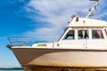 Old white boat shot sidewise against blue sky Royalty Free Stock Photo