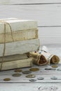 Old white books with money and coins on wooden background Royalty Free Stock Photo