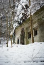 Old white brick building in forest covered with snow Royalty Free Stock Photo