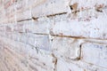 Old white brick wall with crumbling plaster Royalty Free Stock Photo