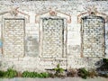 Old white brick wall with three bricked windows Royalty Free Stock Photo