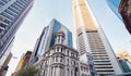 Old white building and tall office buildings rising towards blue sky in Sydney