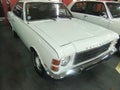 Old white cars with black and silver details, orange in the headlights. Automobile museum in Curitiba