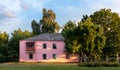 Old white cottage in cozy town. Street view landscape old cirty, little houses on sunset. Old architecture front view. Royalty Free Stock Photo