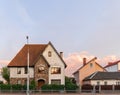 Old white cottage in cozy town. Street view landscape old cirty, little houses on sunset. Old architecture front view. Royalty Free Stock Photo
