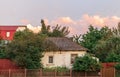 Old white cottage in cozy town. Street view landscape old cirty, little houses on sunset. Old architecture front view. Royalty Free Stock Photo