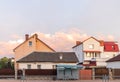 Old white cottage in cozy town. Street view landscape old cirty, little houses on sunset. Old architecture front view Royalty Free Stock Photo