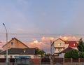 Old white cottage in cozy town. Street view landscape old cirty, little houses on sunset. Old architecture front view Royalty Free Stock Photo