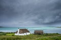 Traditionally built white croft cottage with thatched roof