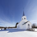 Old white country church in the snow.