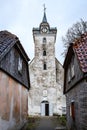 Old white countryside church with tower near small houses in old countryside city Royalty Free Stock Photo