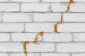 Old white cracked brick wall foamed with polyurethane or construction foam repair and reconstruction of the facade of the building