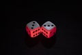 Old white dices with double three and six pair iluminated with red and white lights Royalty Free Stock Photo