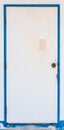 Old white door with blue jamb Royalty Free Stock Photo