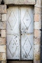 Old white durty, dirty door with rust and hand door knocker a beautiful vintage background