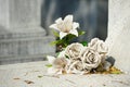 Old white fake flower on grave