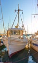 Old white fishing boat in the port of Aegina at sunset Royalty Free Stock Photo