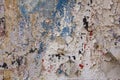 Old white gray damaged concrete wall with cracks and peeling blue red black paint. rough surface texture Royalty Free Stock Photo