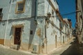 Old white houses with peeling plaster on deserted alley Royalty Free Stock Photo