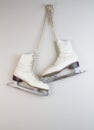 Old white ice skates hanging on the wall Royalty Free Stock Photo