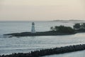 Old white lighthouse on a breakwater at the entrance to Nassau harbour in the Bahamas. Royalty Free Stock Photo