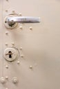 Old white metal door with lock, key and heck or door handle Royalty Free Stock Photo