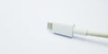 The old white micro USB cable plug, negative space, isolated on the gray white background. Royalty Free Stock Photo