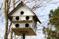 Old white multiple hole rural country birdhouse