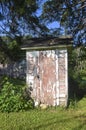 Old white outhouse