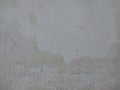 Old white paint texture peeling off concrete wall.Grunge Background Texture, Abstract Dirty Splash Painted Wall. Royalty Free Stock Photo