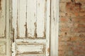 Old, white painted doors, closed, indoors with red brick wall Royalty Free Stock Photo