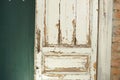 Old, white painted doors, closed, indoors with red brick wall and green wall Royalty Free Stock Photo