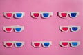 Old white paper 3d glasses with blue and red lenses on a pink background with copy space. Retro stereoscopic 3D Royalty Free Stock Photo