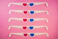 Old white paper 3d glasses with blue and red lenses on a pink background. Retro stereoscopic 3D cardboard glasses for Royalty Free Stock Photo