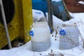 An old white plastic barrel is thrown into the snow Royalty Free Stock Photo