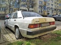 White veteran vintage classic old white sedan car Mercedes Benz 190E parked