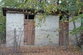 old white rustic brick barn with two brown wooden doors Royalty Free Stock Photo