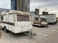 Old white rusty caravan trailers, mobile homes are parked